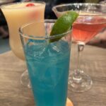 drinking on a budget on a carnival cruise, three specialty drinks sit on a table