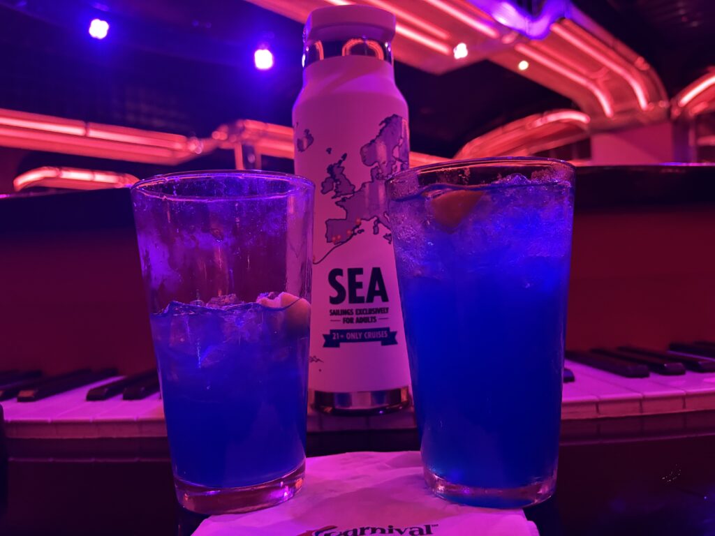 two Blue note piano bar drinks carnival cruise line, pictured with a SEA water bottle showing the transatlantic journey